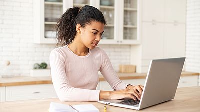 International woman using a laptop to search for information on the internet